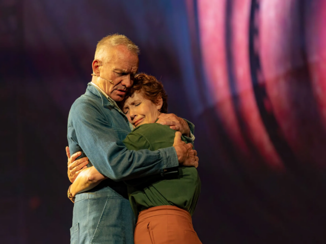 Jackie and Peggy White hold each other tightly, eyes closed.